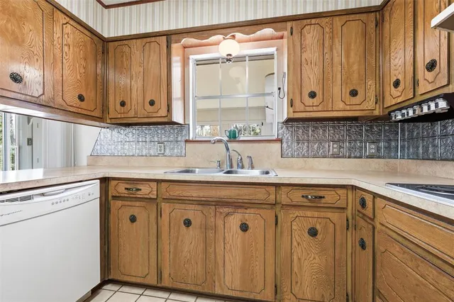a kitchen with stainless steel appliances granite countertop a sink and cabinets