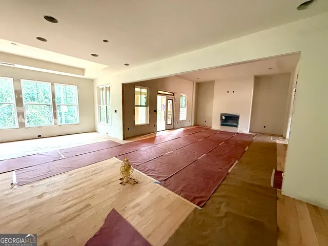 a spacious bedroom with a large bed and large windows