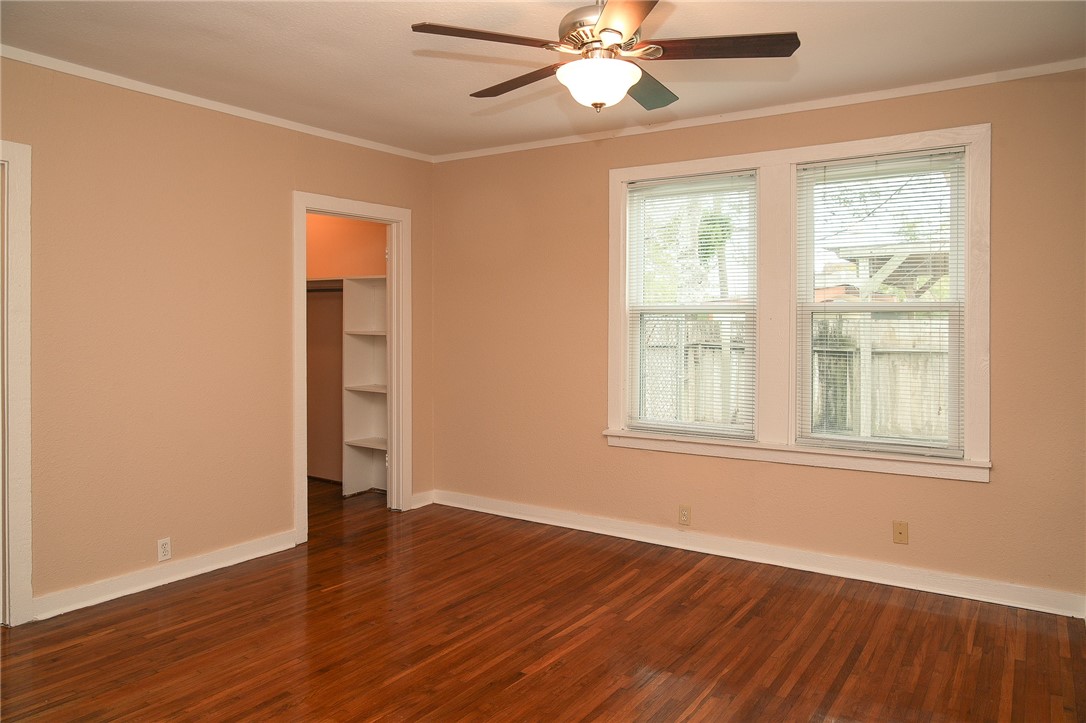 641 Naples Street Corpus Christi, TX 78404 - Photo 11 of 29 a view of an empty room with wooden floor and a window