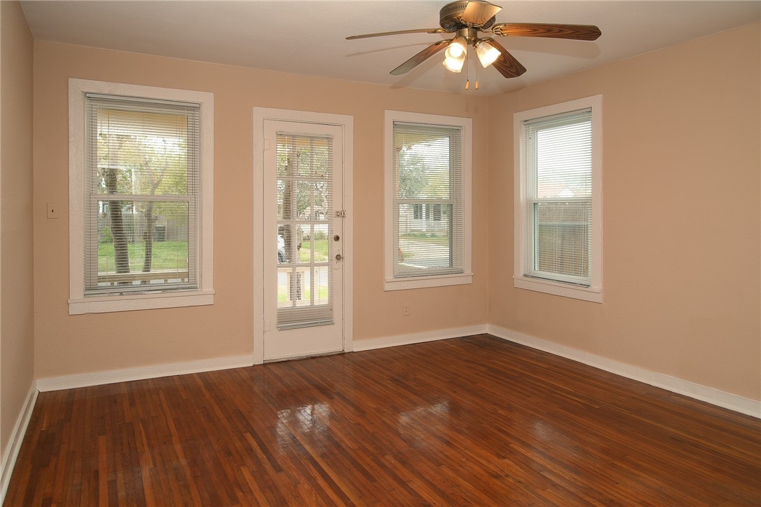 641 Naples Street Corpus Christi, TX 78404 - Photo 14 of 29 a view of an empty room with wooden floor and window