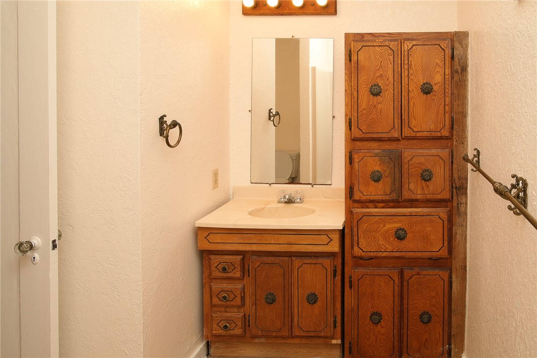 641 Naples Street Corpus Christi, TX 78404 - Photo 16 of 29 a bathroom with a sink a mirror and shower