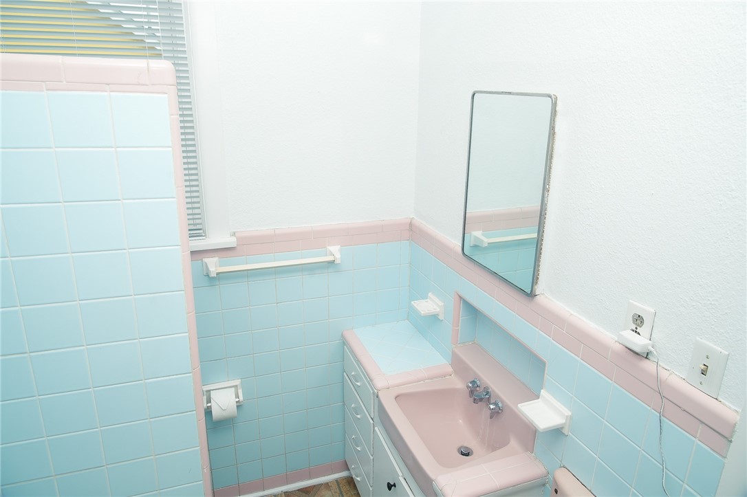 641 Naples Street Corpus Christi, TX 78404 - Photo 19 of 29 a bathroom with a sink and a mirror