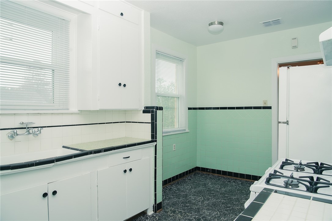 641 Naples Street Corpus Christi, TX 78404 - Photo 20 of 29 a kitchen with a refrigerator and a stove