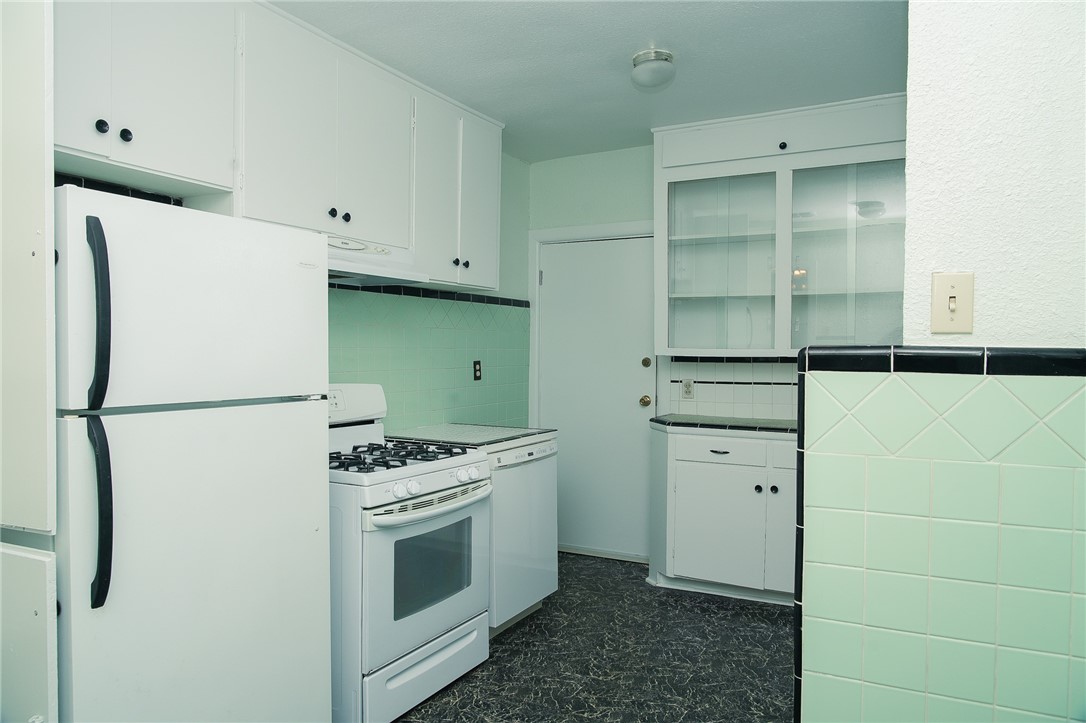 641 Naples Street Corpus Christi, TX 78404 - Photo 21 of 29 a kitchen with cabinets and white stainless steel appliances