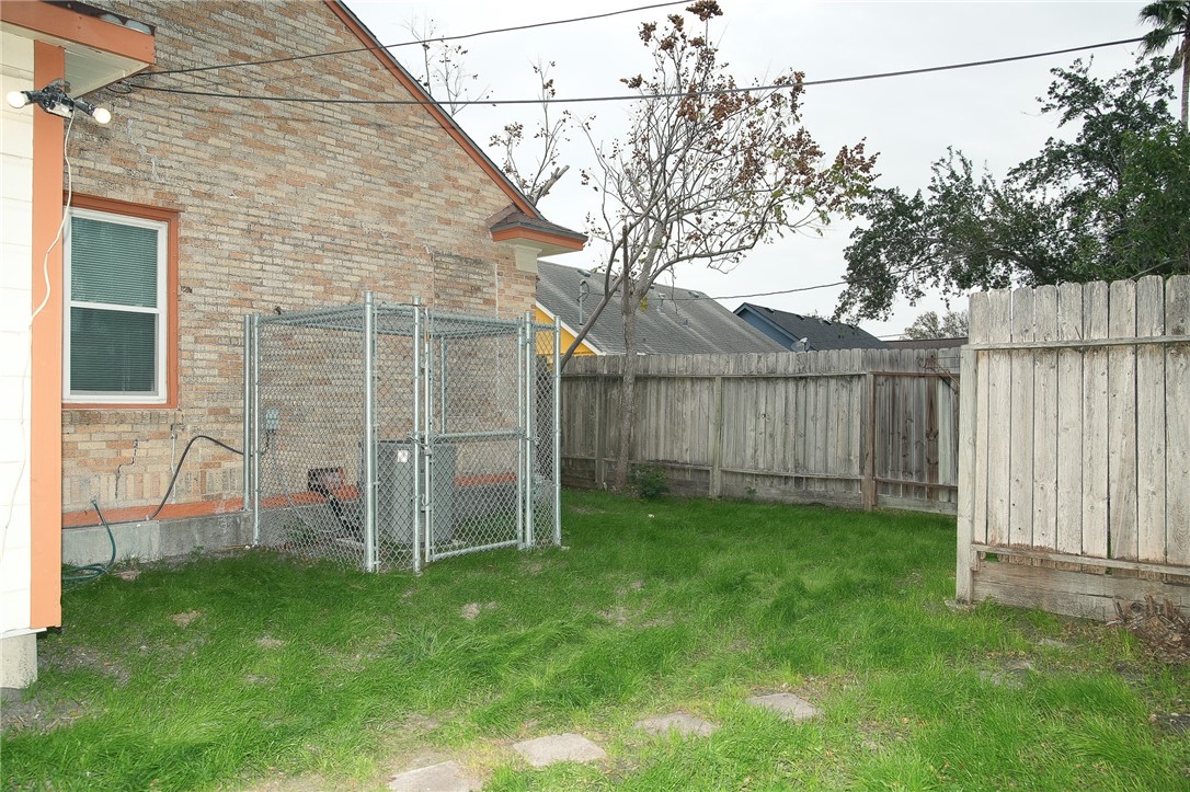 641 Naples Street Corpus Christi, TX 78404 - Photo 27 of 29 a view of a backyard with wooden fence and a bench