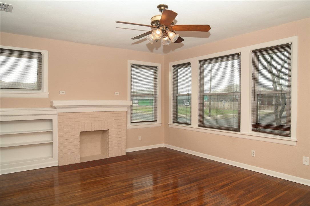 641 Naples Street Corpus Christi, TX 78404 - Photo 4 of 29 a view of an empty room with wooden floor and a window