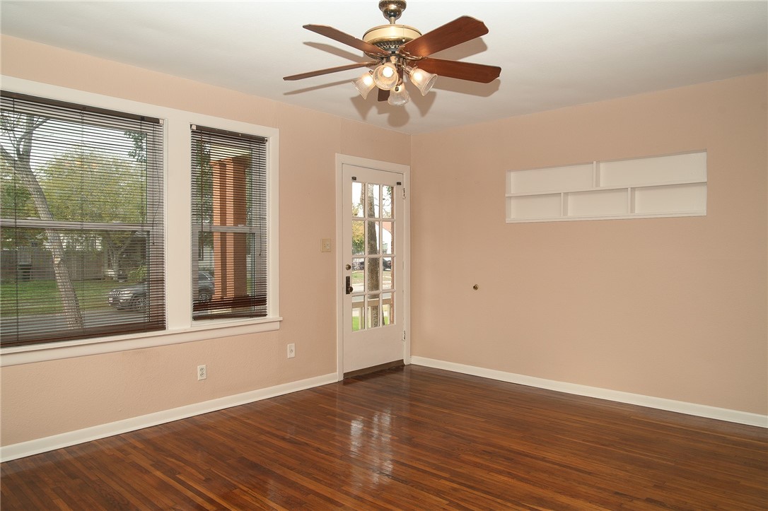 641 Naples Street Corpus Christi, TX 78404 - Photo 5 of 29 a view of an empty room with a window and wooden floor