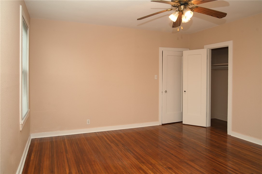 641 Naples Street Corpus Christi, TX 78404 - Photo 8 of 29 an empty room with wooden floor and windows