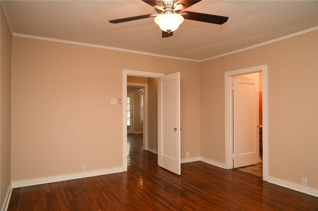 641 Naples Street Corpus Christi, TX 78404 - Photo 10 of 29 an empty room with wooden floor closet and windows