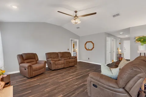 a living room with furniture and a ceiling fan