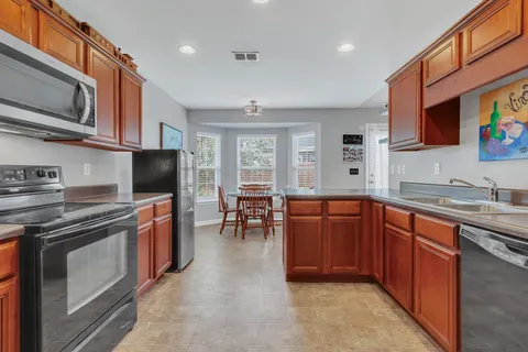 a kitchen with stainless steel appliances granite countertop sink microwave and stove