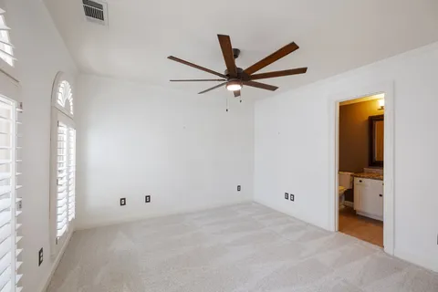 a view of a livingroom with a ceiling fan and window