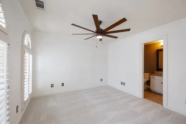 a view of a livingroom with a ceiling fan and window