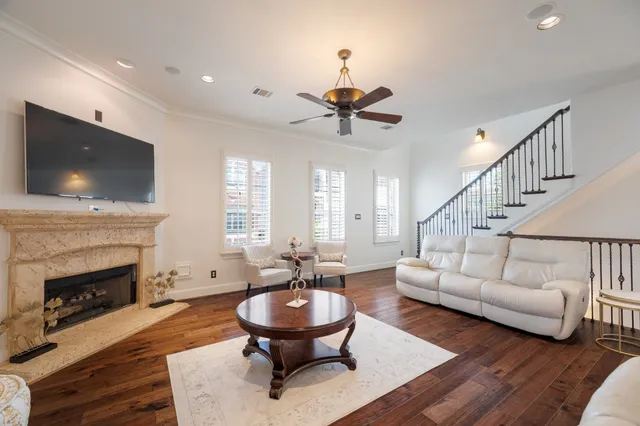 a living room with furniture a fireplace and a flat screen tv