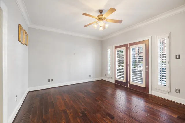 an empty room with wooden floor and window