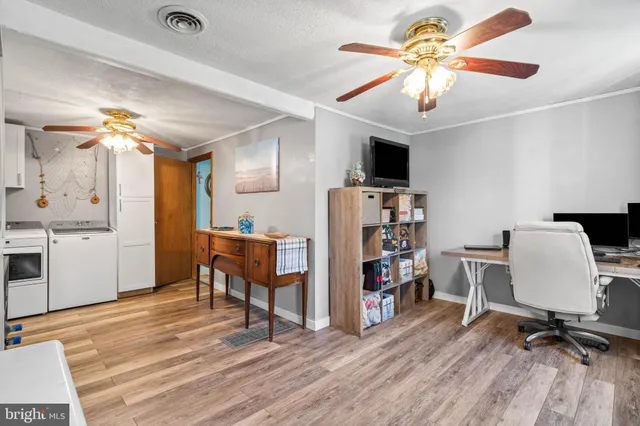 a view of a workspace with furniture and a kitchen