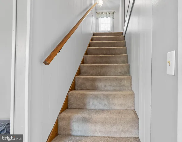 a view of staircase with white walls