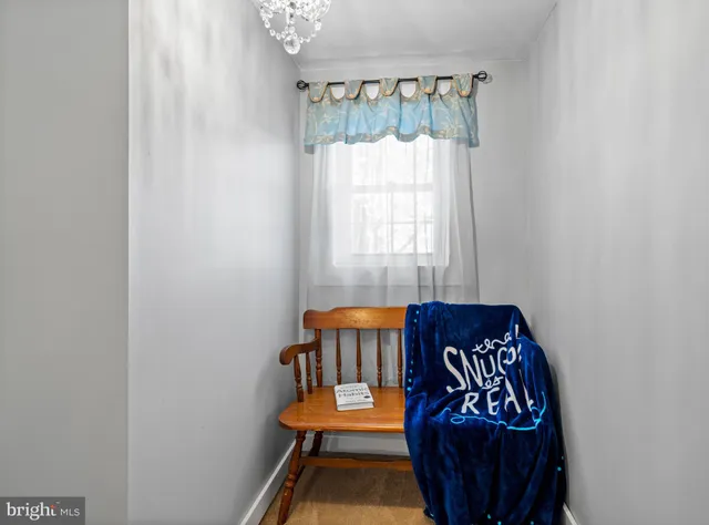 a bedroom with a bed a window and a chandelier