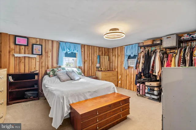 a bedroom with a bed and a walk in closet