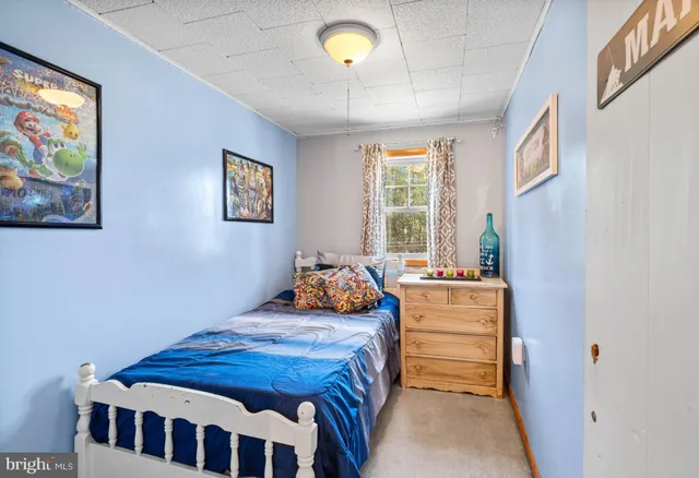 a bedroom with bed and a window