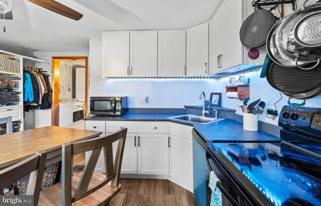 a kitchen with stainless steel appliances a stove a sink and a refrigerator