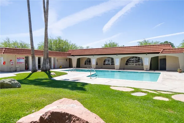a front view of house with a garden and patio
