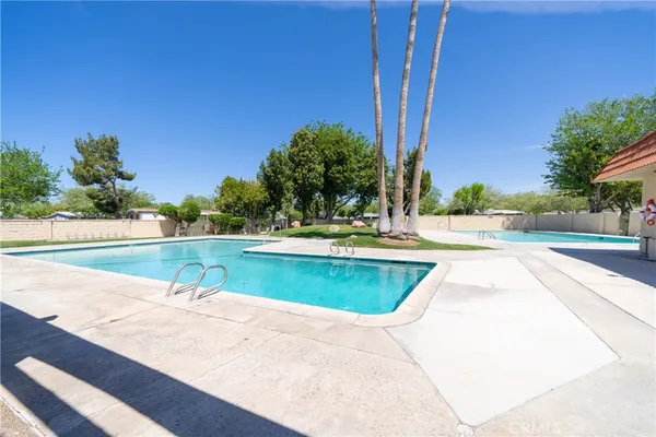 a view of a swimming pool with a yard