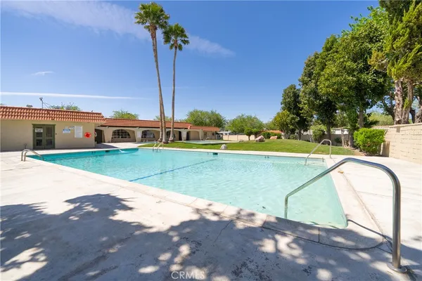a view of a swimming pool with a yard