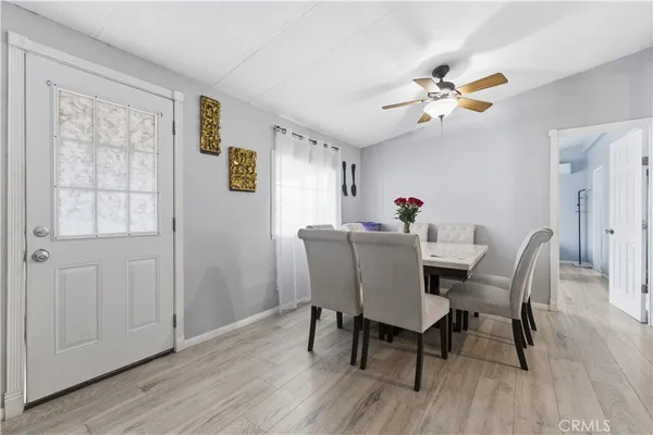 a dining room with furniture a window and wooden floor