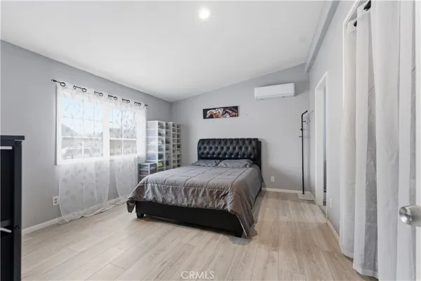 a bedroom with a bed and a window