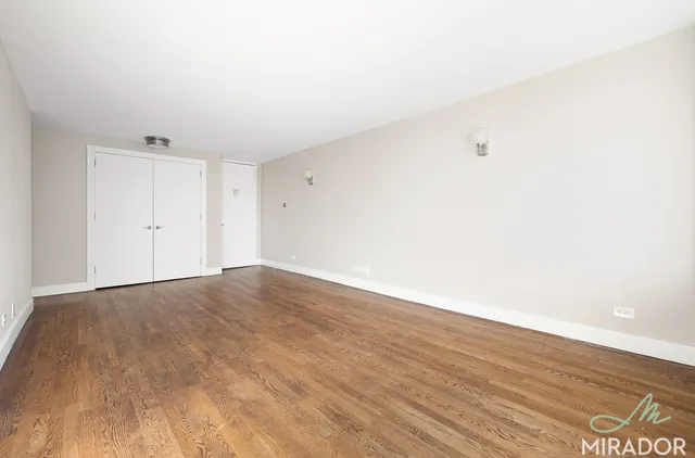 a view of an empty room and wooden floor