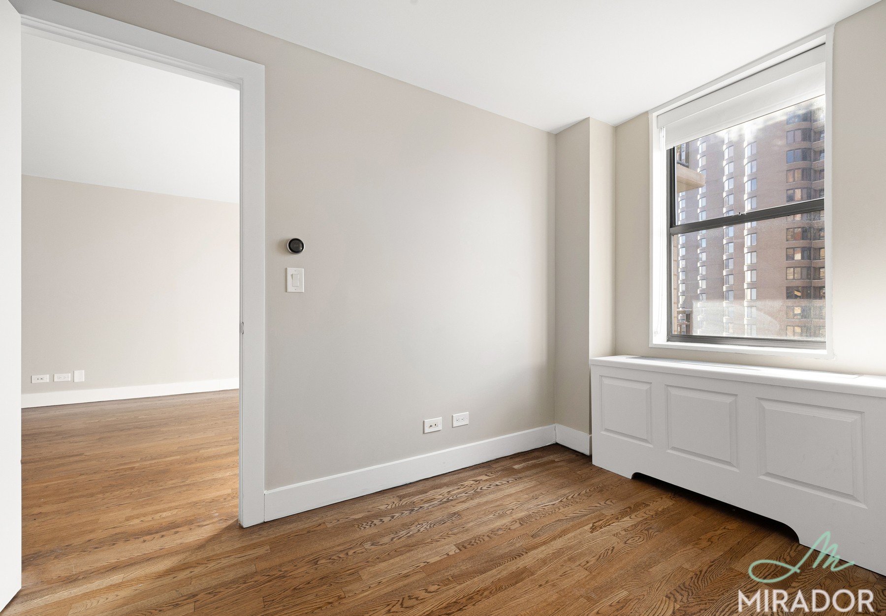 330 East 39th Street, Unit 15C Manhattan, NY 10016 - Photo 9 of 24 an empty room with wooden floor and windows