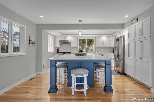 a living room with fireplace furniture and a wooden floor