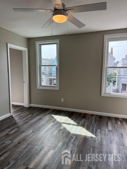 443 Fulton Street, Unit 2 Elizabeth, NJ 07206 - Photo 3 of 9 an empty room with wooden floor and windows