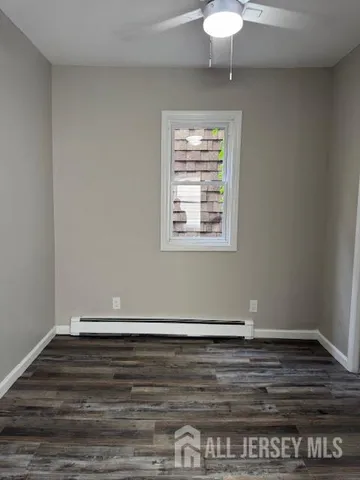 a view of wooden floor and a chandelier fan in a room