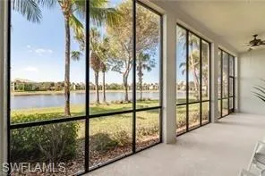 a view of a lake with a big yard and palm trees