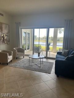 9271 Museo Circle, Unit 102 Naples, FL 34114 - Photo 3 of 13 a living room with furniture and a floor to ceiling window