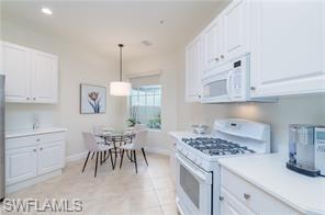 9271 Museo Circle, Unit 102 Naples, FL 34114 - Photo 7 of 13 a kitchen with a table and chairs