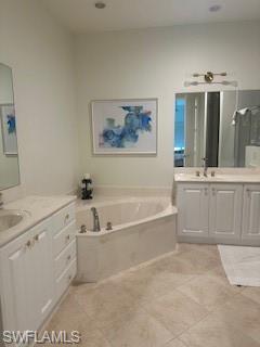 9271 Museo Circle, Unit 102 Naples, FL 34114 - Photo 9 of 13 a spacious bathroom with a tub a double vanity sink and mirror
