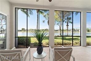 9271 Museo Circle, Unit 102 Naples, FL 34114 - Photo 10 of 13 a living room with a large window and a potted plant