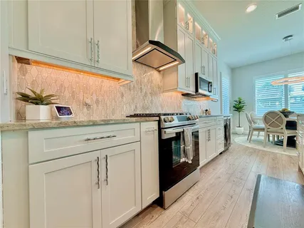 a large kitchen with kitchen island a large counter top