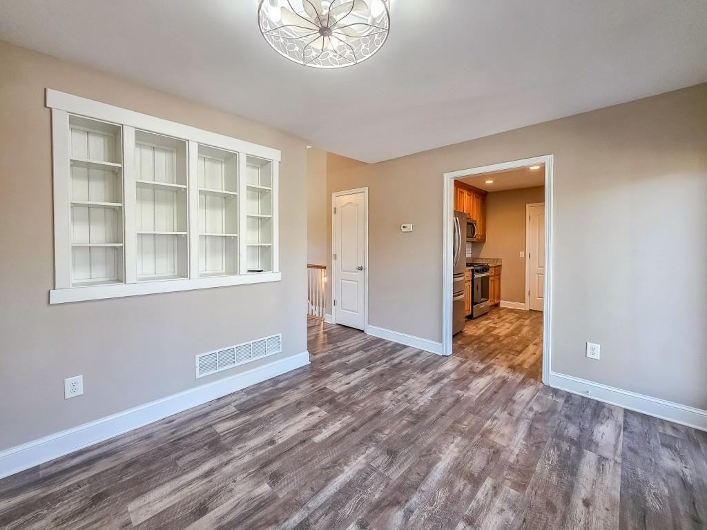 165 Horseshoe Bend Jasper, GA 30143 - Photo 13 of 44 a view of an empty room with wooden floor and a window