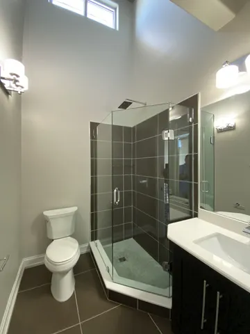 a bathroom with a toilet a sink and shower