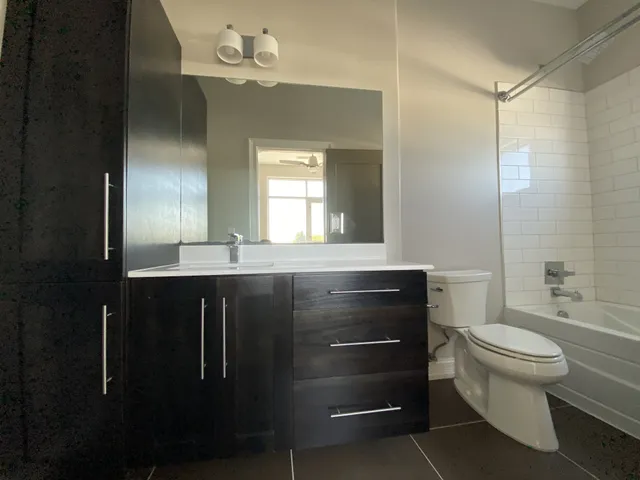 a bathroom with a sink a toilet and a mirror