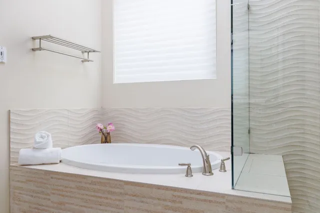 a bathroom with a bathtub and shower