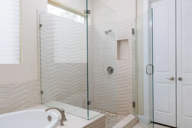 a en suite bathroom with a double vanity sink and a mirror