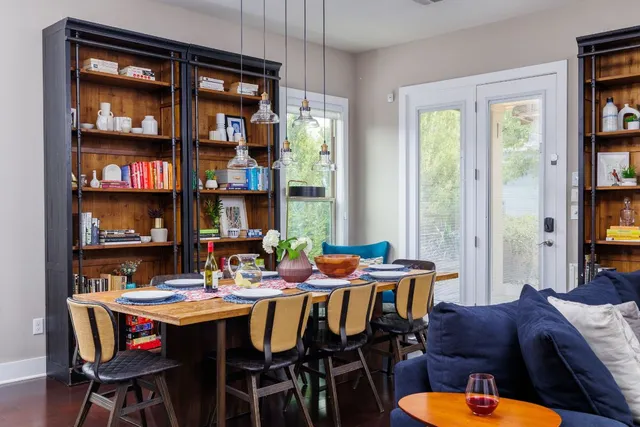 a kitchen with a sink a stove and chairs