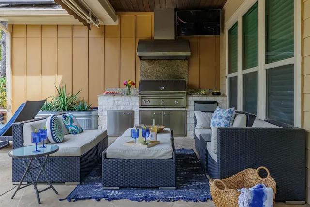 a view of a backyard with chairs and a table