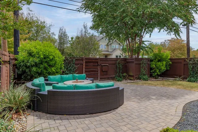 a view of a backyard with outdoor seating