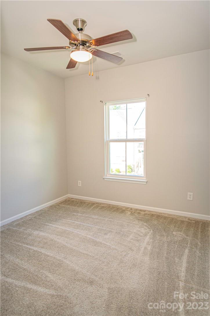 12725 Glowing Peak Road Huntersville, NC 28078 - Photo 11 of 17 an empty room with a window and a fan